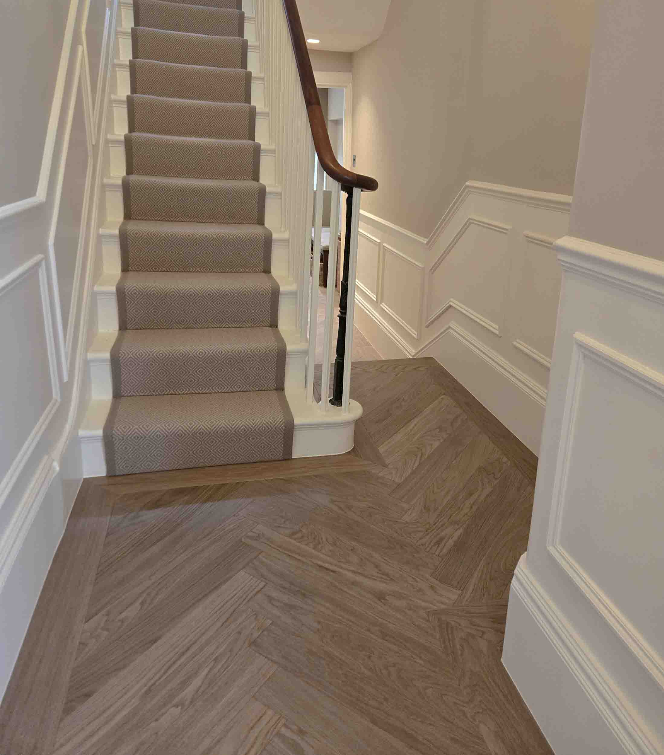 grey brown herringbone wood flooring in entrance hall