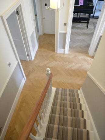 Prime Oak Herringbone Wood Flooring next to Stairs