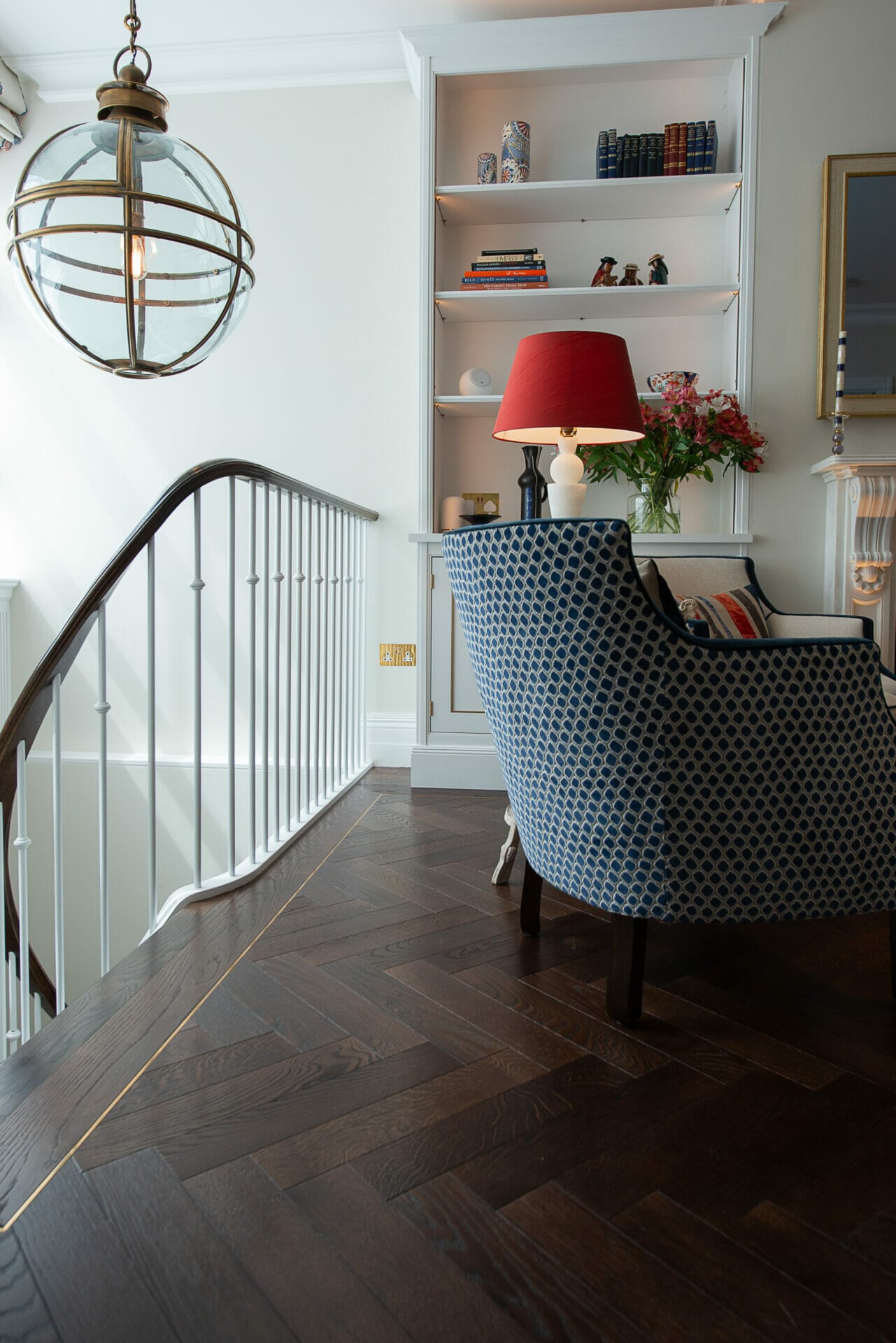 dark oak herringbone flooring with brass inset strip