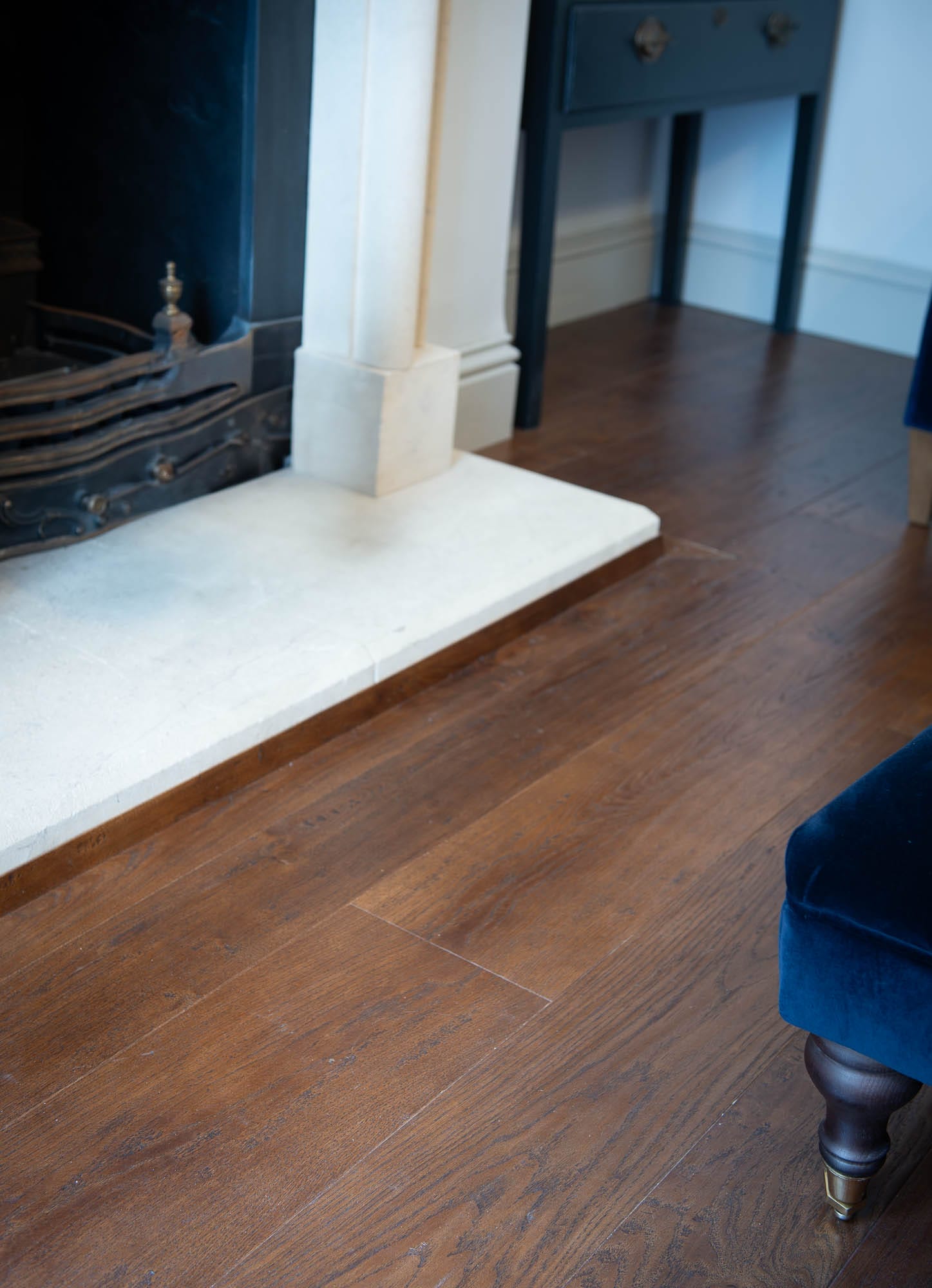 Aged Oak Flooring Old English Dark Brown Oak with traditional fireplace